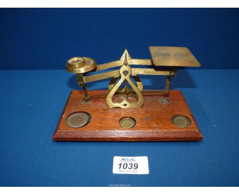 A Brass postal Scales with odd weights.