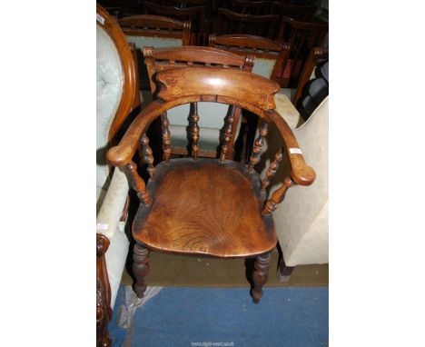 A solid Elm seated Captains Chair having turned legs, stretchers and back supports, sold together with a tapestry cushion.