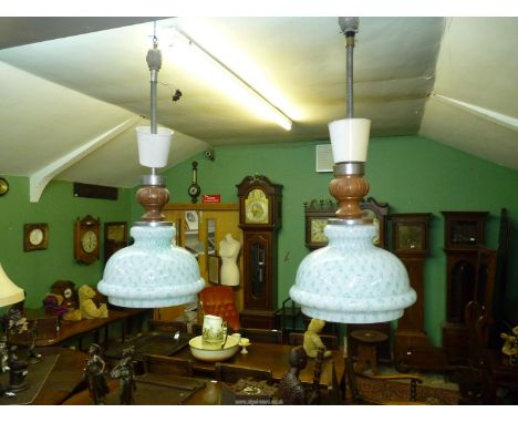 A pair of vintage glass ceiling lights, white with overall decoration of green/light blue spots.