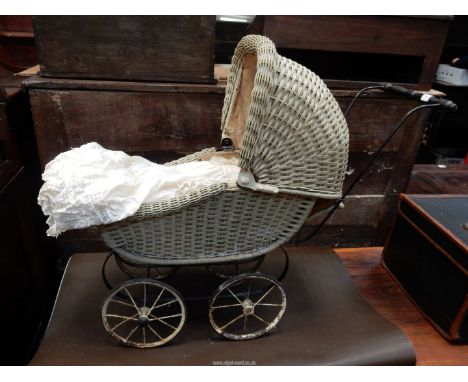 A vintage dolls pram with a German doll (as found).