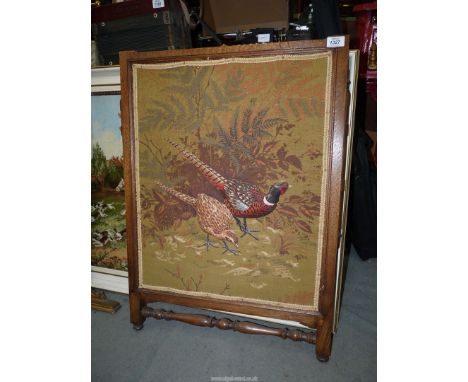 An oak framed firescreen (no supports) with fabric panel depicting Cock and Hen pheasant with padded bodies, 23" wide x 32" h