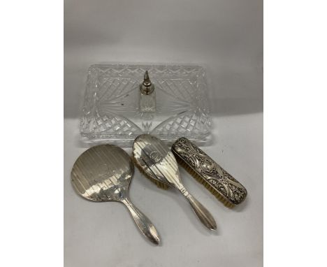 A MATCHED DRESSING TABLE SET COMPRISING HALLMARKED SILVER BRUSHES &amp; MIRROR, SILVER TOPPED ATOMISER AND CUT GLASS TRAY 