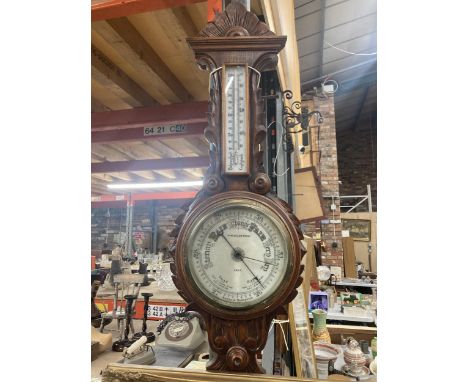 A W W GOLDSTRAW ANEROID BAROMETER IN A CARVED MAHOGANY CASE 