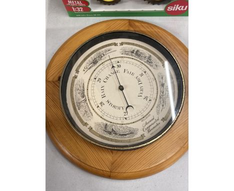 A VINTAGE PINE FRAMED ROUND ANEROID BAROMETER DIAMETER APPROX 30CM 
