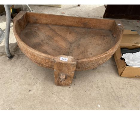 A LARGE DECORATIVE TREEN INDIAN HALF ROUND TROUGH 