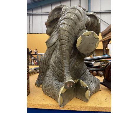 A LARGE MODEL OF A SEATED ELEPHANT 