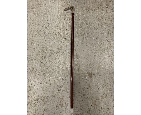 A VINTAGE WALKING STICK WITH A DECORATIVE WHITE METAL HANDLE 
