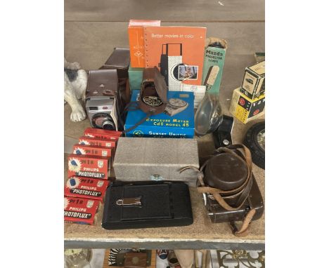 A VINTAGE KODAK BROWNIE MOVIE CAMERA IN CASE TOGETHER WITH BOXED PHOTOFLUX PF1B BOXED FLASH'S, MAZDA PROJECTOR LAMP, EXPOSURE