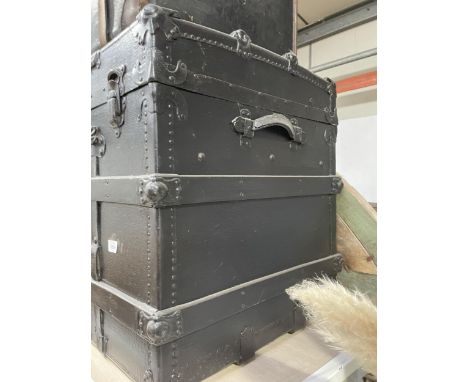 A BLACK PAINTED TRAVELLING TRUNK 