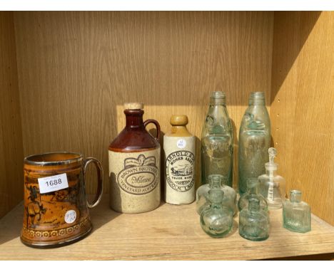 AN ASSORTMENT OF VINTAGE GLASS BOTTLES AND STONEWARE VESSELS SOME BEARING NAMES 