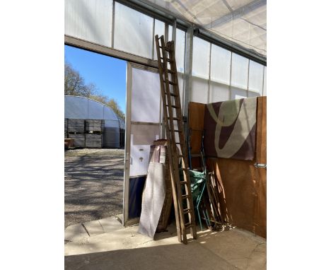 A TWO SECTION VINTAGE WOODEN EXTENDABLE 30 RUNG LADDER 