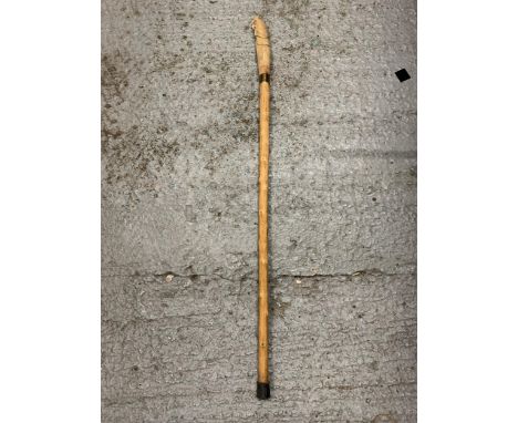 A WOODEN WALKING STICK WITH A CARVED OWL FINIAL 