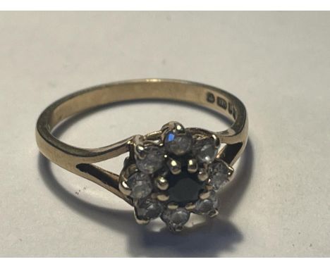 A 9 CARAT GOLD RING WITH A CENTRE SAPPHIRE SURROUNDED BY CUBIC ZIRCONIAS SIZE K/L 