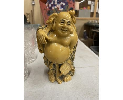 A VINTAGE STYLE RESIN MODEL OF A BUDDAH 
