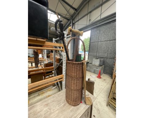 A WICKER STICK STAND WITH ASSORTED WALKING STICKS 