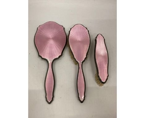 AN ART DECO HALLMARKED SILVER AND PINK ENAMEL THREE PIECE DRESSING SET, HALLMARKS FOR BIRMINGHAM, 1927, MAKERS ADIE BROTHERS 