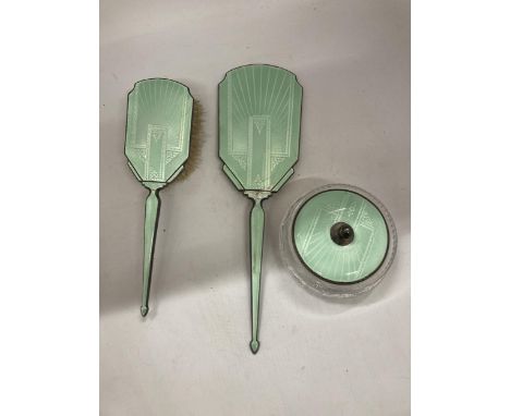 AN ART DECO HALLMARKED SILVER AND FLORAL GREEN ENAMEL THREE PIECE DRESSING SET 