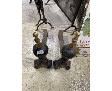 A PAIR OF VINTAGE FIRE DOGS WITH BRASS TOPS 