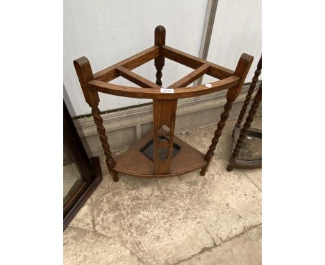 AN EARLY 20TH CENTURY OAK CORNER STICK STAND ON BARLEYTWIST LEGS 