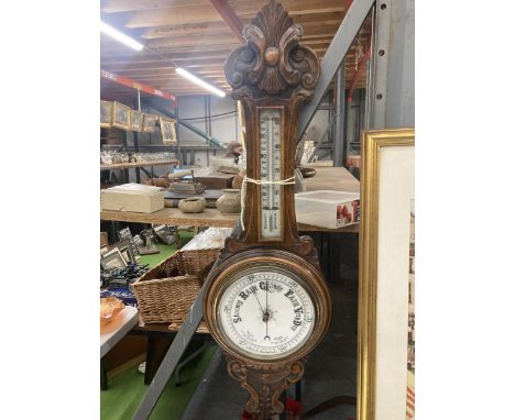 A VINTAGE CARVED MAHOGANY CASED ANEROID BAROMETER 