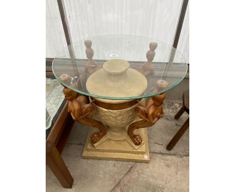 A RESIN LAMP TABLE ON URN SHAPED BASE SUPPORTED BY MYTHICAL FIGURES WITH GLASS TOP, 23.5" DIAMETER 