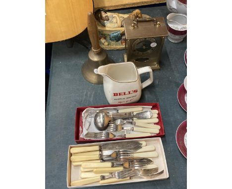 A MIXED LOT TO INCLUDE FLATWARE, A BELL'S WHISKY WATER JUG, BRASS BELL, FIGURE AND MANTLE CLOCK 