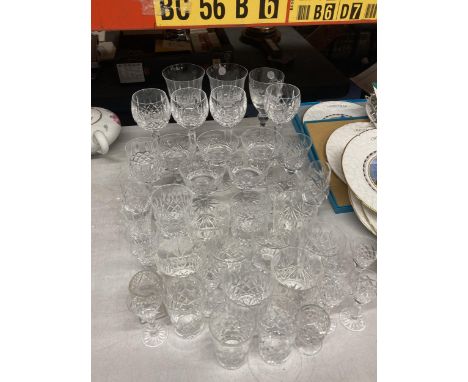 A LARGE QUANTITY OF CRYSTAL DRINKING GLASSES AND DESSERT BOWLS TO INCLUDE RED AND WHITE WINE, WHISKEY TUMBLERS, SHERRY GLASSE