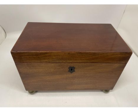 A VICTORIAN MAHOGANY TEA CADDY WITH THREE INNER COMPARTMENTS, ON BUN FEET 