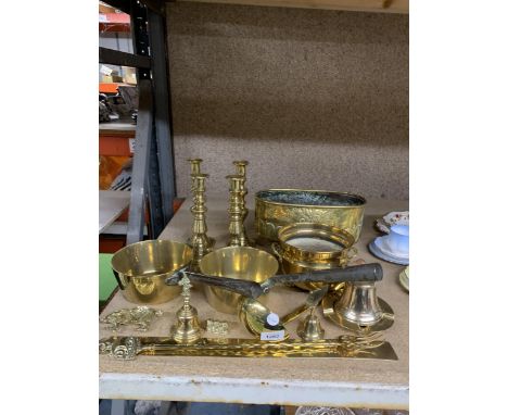 A LARGE QUANTITY OF BRASSWARE TO INCLUDE CANDLESTICKS, PLANTER, PANS, BELLS, ETC., 