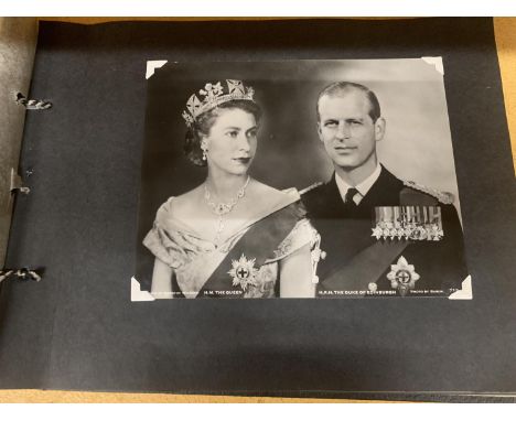 A VINTAGE PHOTOGRAPH ALBUM CONTAINING A QUANTITY OF ROYAL COMMEMORATIVE POSTCARDS OF QUEEN ELIZABETH II AND FAMILY 