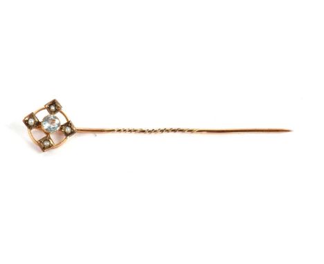 An aquamarine and seed pearl stick pin, set with a central round aquamarine within a circular frame set with four seed pearls