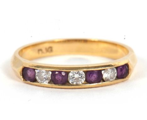 An 18ct amethyst and diamond ring, the alternating round amethyst and round brilliant cut diamonds, channel set with plain ba