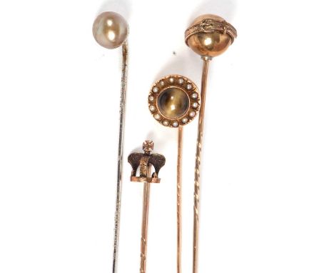 Four stick pins: to include an unmarked cats eye chrysoberyl and seed pearl pin, 11mm diameter, 1.4g; an unmarked belted sphe
