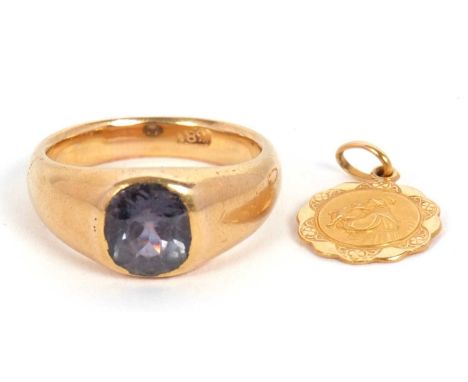 A gemset ring and a medalllion: the ring set with a blue-green stone, possibly a sapphire, in a rubover mount with tapering s