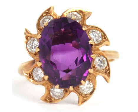 An 18ct amethyst and diamond ring, the oval amethyst surrounded by tapered petals set with a round brilliant cut diamond, tot