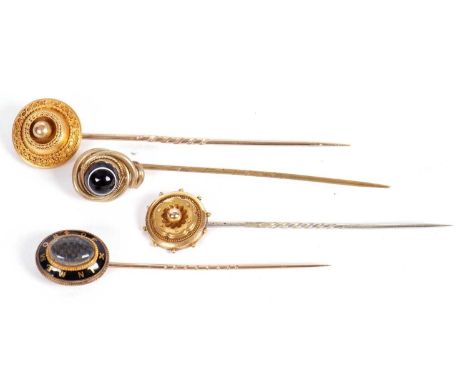 Four stick pins: to include a 19th century oval memorial pin with glazed hairwork keepsake panel, 2.9g; an unmarked Etruscan 
