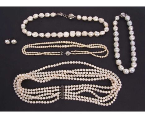 A quantity of cultured pearls: to include a five strand necklace with sliding clasp stamped 925; a graduated two strand neckl