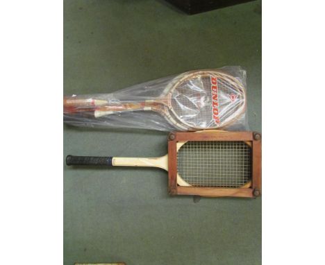A vintage Slazenger tennis racket in press and an unstrung "Maxply" example together with two vintage badminton rackets