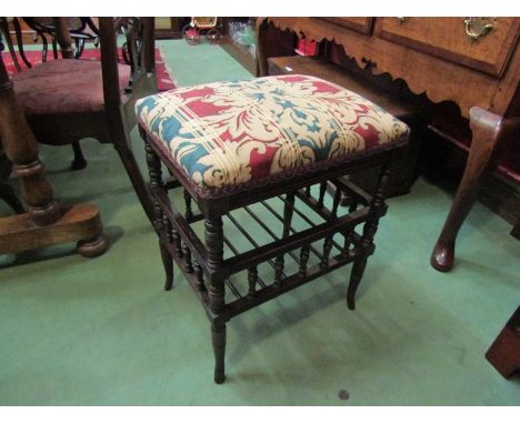 A late Victorian walnut piano stool on ring turned and spindle base with outswept feet, 57cm high x 46cm wide