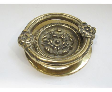 A heavy brass door knocker, 14cm diameter