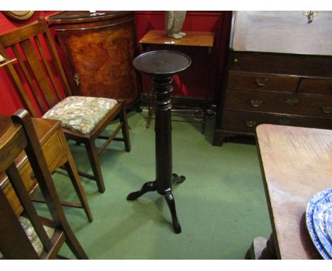 A 19th Century mahogany jardiniere stand, the circular dished top on turned and carved column with tripod base, 90cm high