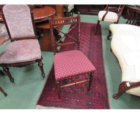 A pair of Arts &amp; Crafts walnut chairs in the manner of Jas. Shoolbred, the ring turned "X" frame backrests over turned an