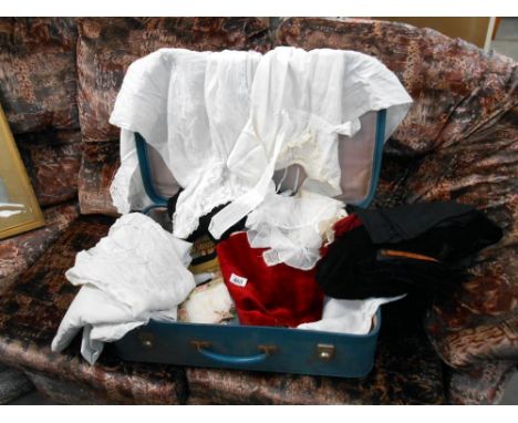 A case of assorted linen in vintage suitcase
