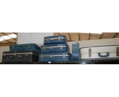 A set of 3 vintage graduated matching suitcases plus quantity of others (1 missing handle)