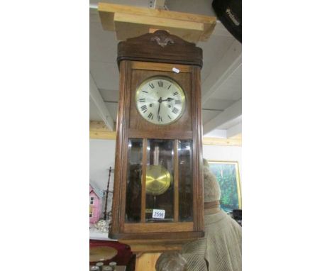 A 1930's oak wall clock, a/f (spring broken).