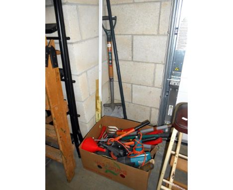 A box of garden tools, spade etc.