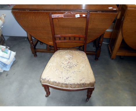 An Edwardian nursing chair with floral tapestry seat