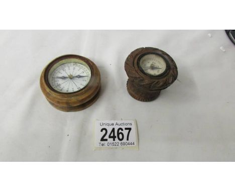 A boxwood compass circa 1890 (missing lid) and a carved wooden compass.