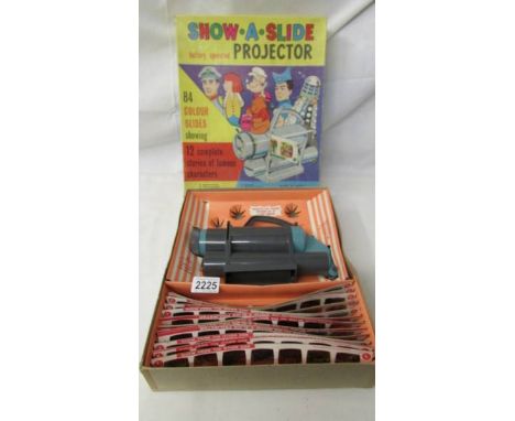 A Show a Slide battery operated projector with 84 colour slides showing 12 complete stories of famous characters including St