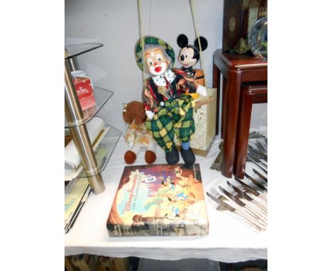 A Disney Mickey Mouse money box, Disney animation book, clown puppet and a rag doll